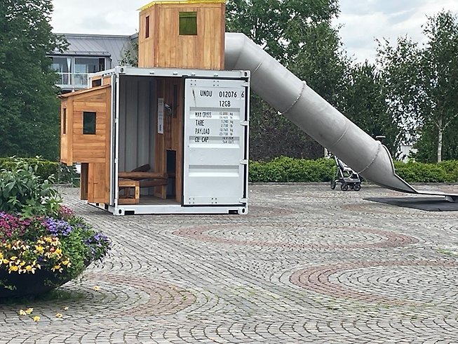 En lekplats gjord av container och träslag med rutchkana på Stortorget.