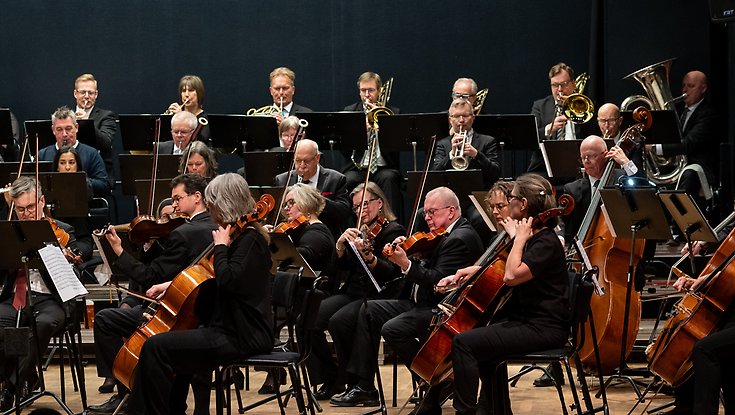 en orkester som spelar på en scen