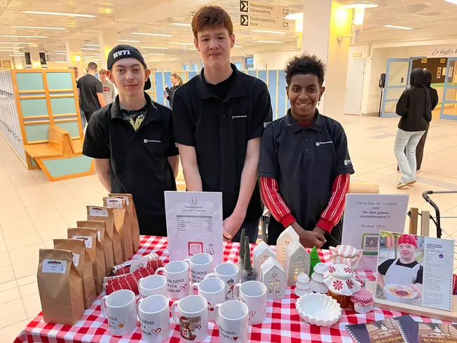 Foto på tre elever som säljer olik saker.